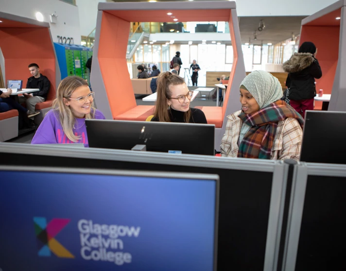 Three students using desktop computers and working together in the Springburn campus library at Glasgow Kelvin College Three students using desktop computers and working together in the Springburn campus library at Glasgow Kelvin College